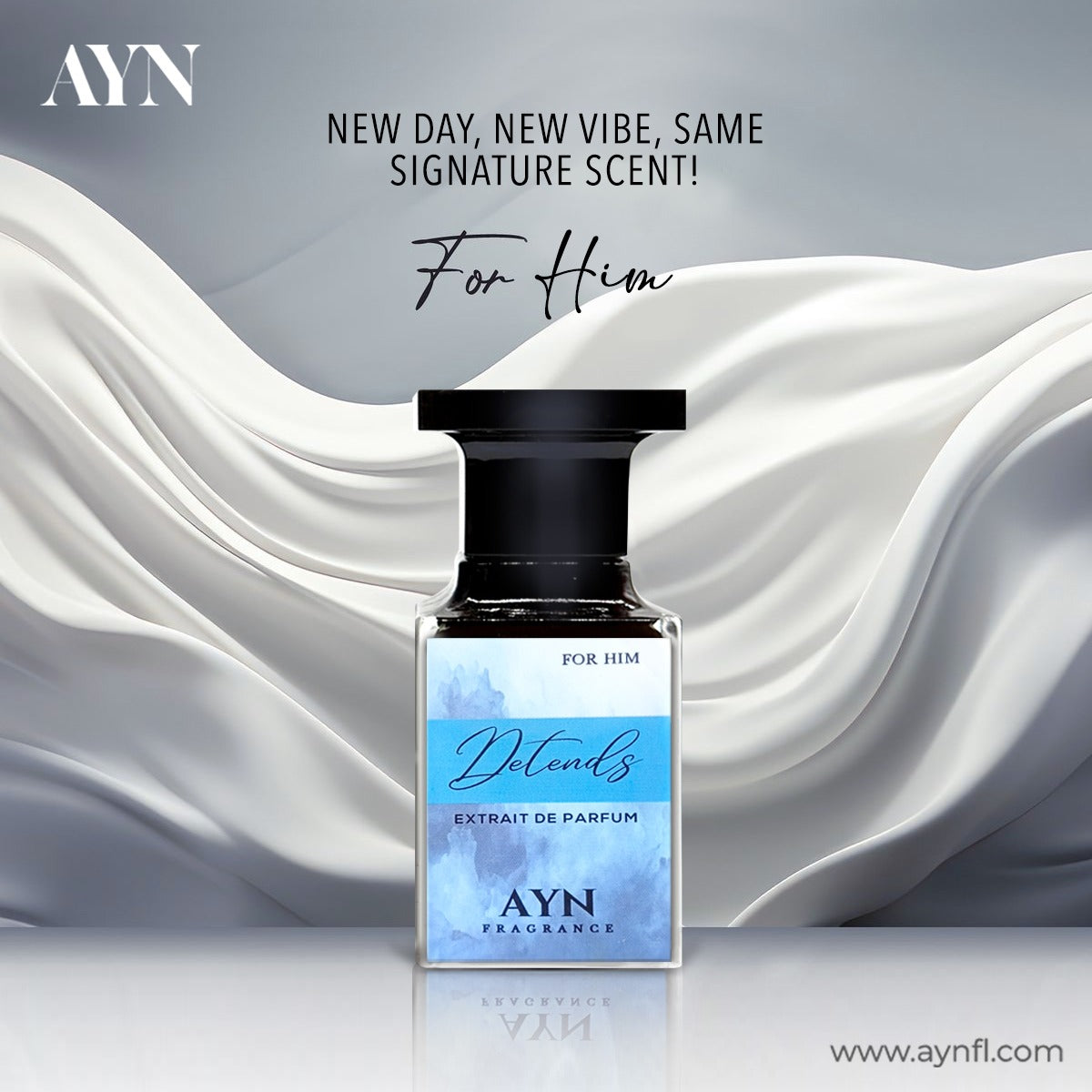 A bottle of AYN For Him Detonds Extrait de Parfum is centered against a stylized background of flowing white satin drapery and a gray gradient. The product has a black cap and a light blue watercolor label with white text.